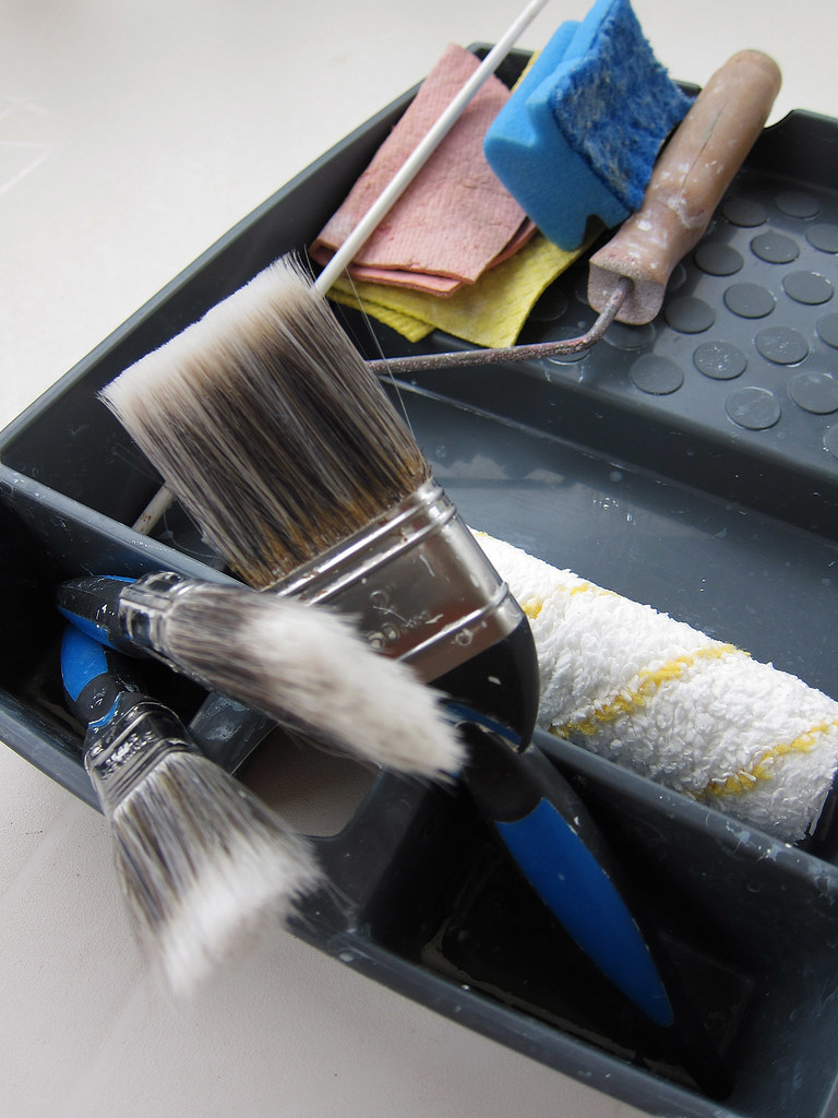 Paint brushes and a roller tray, ready for a job